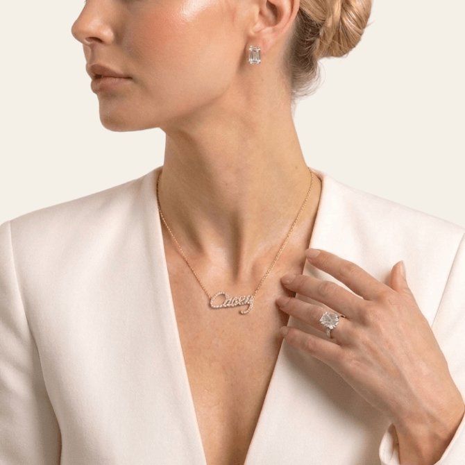 Model wearing a David Von custom name necklace, diamond studs and ring